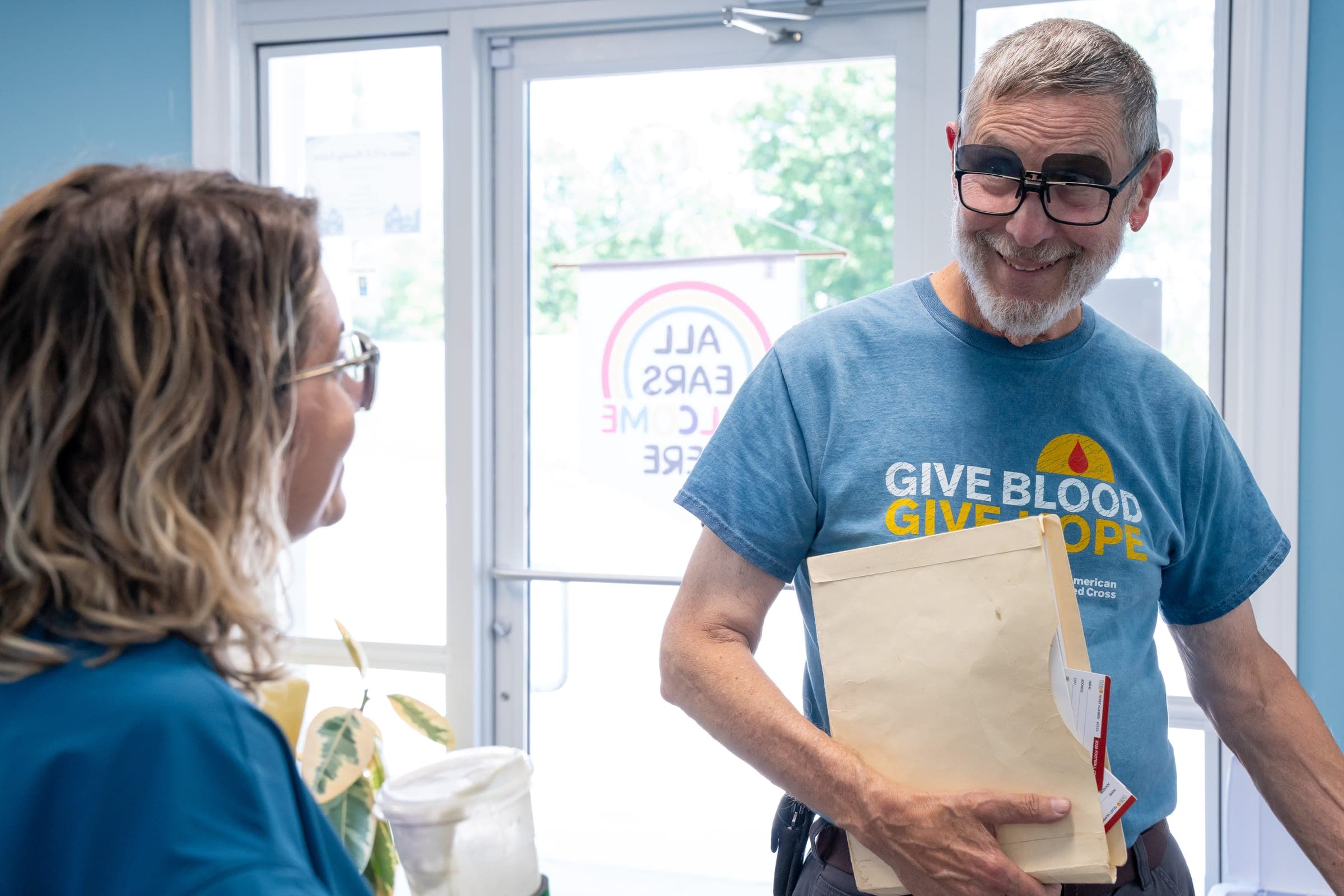 A smiling visitor arriving at Sounds of Life Hearing Center