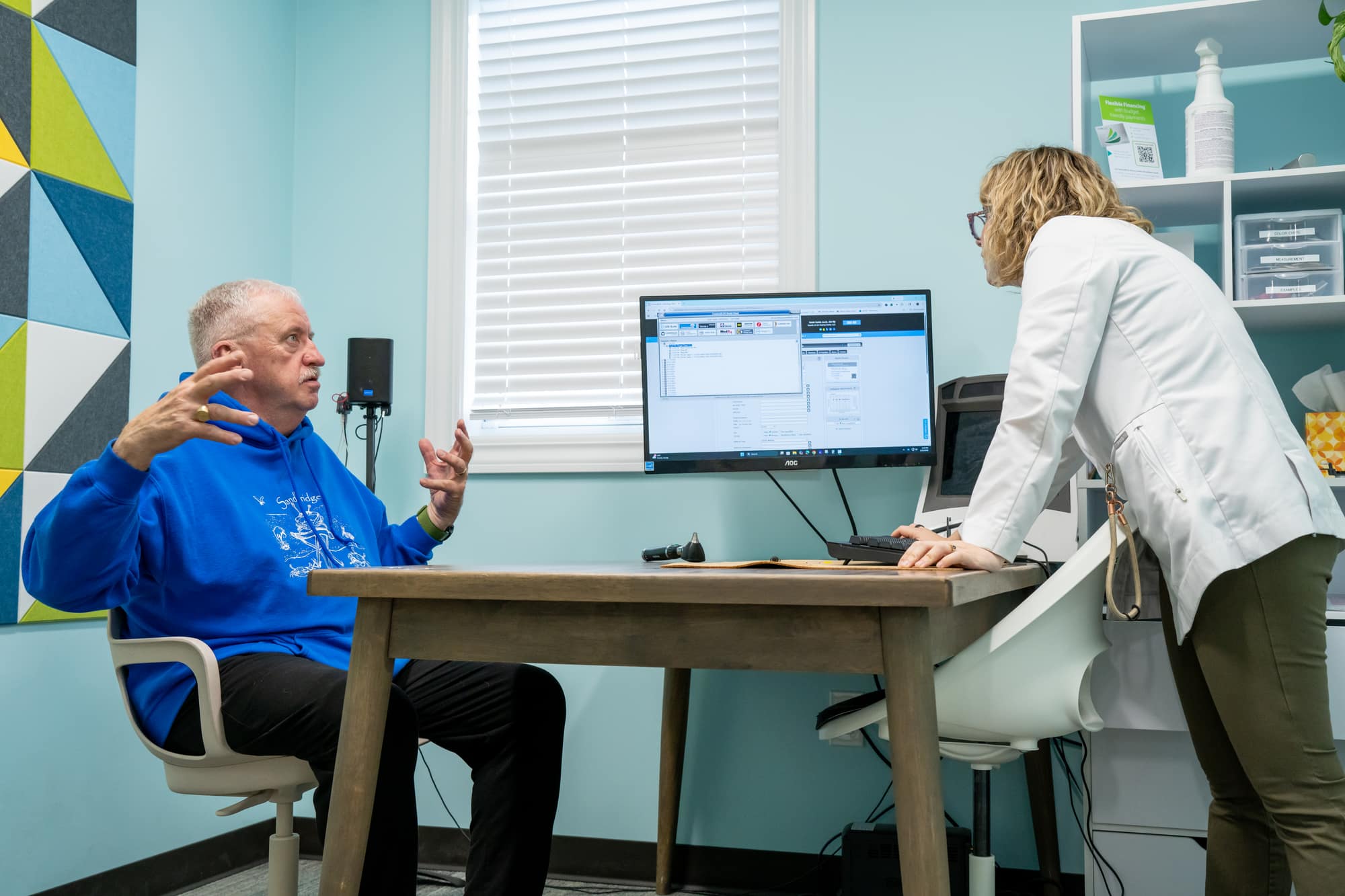 Audiologist consulting with patient about hearing test results